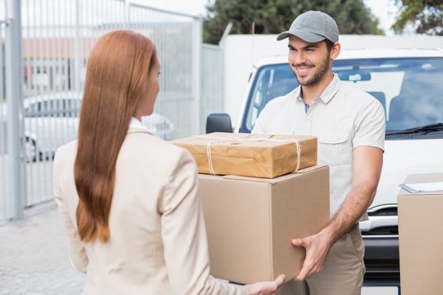 bigstock-Delivery-driver-passing-parcel-73177681.jpg